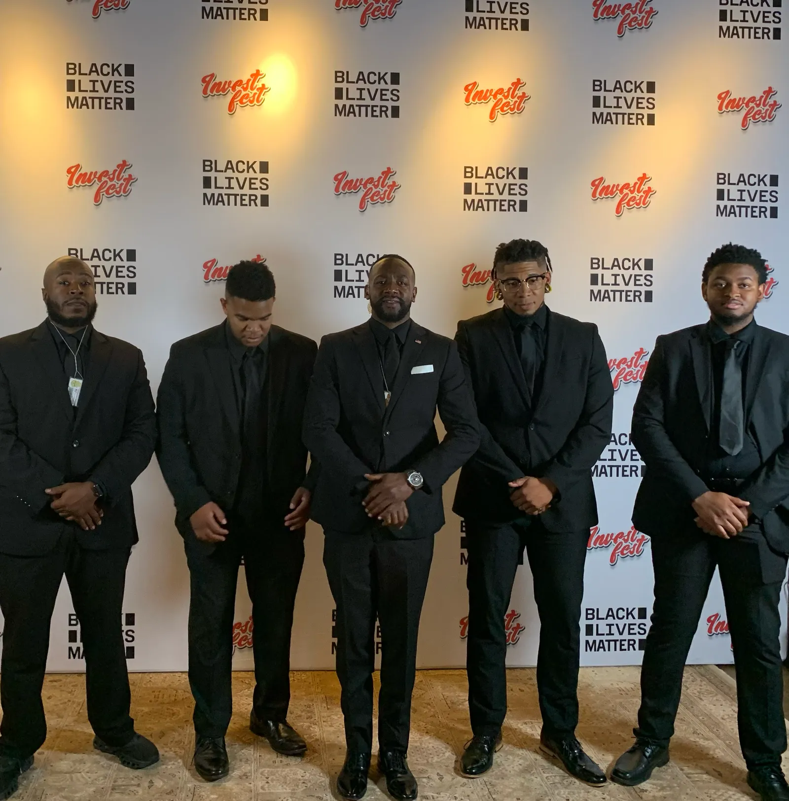 Kinetic Protection Group executive protection detail in suits at a client event